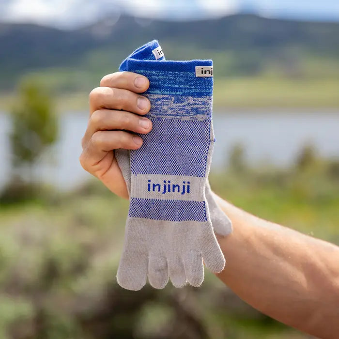 Injinji Trail Midweight Mini Crew Mens Neptune man holding the socks
