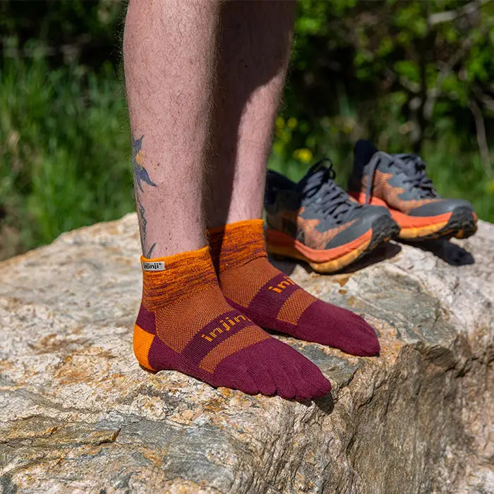 Injinji Trail Midweight Mini Crew Mens standing Solar on rock
