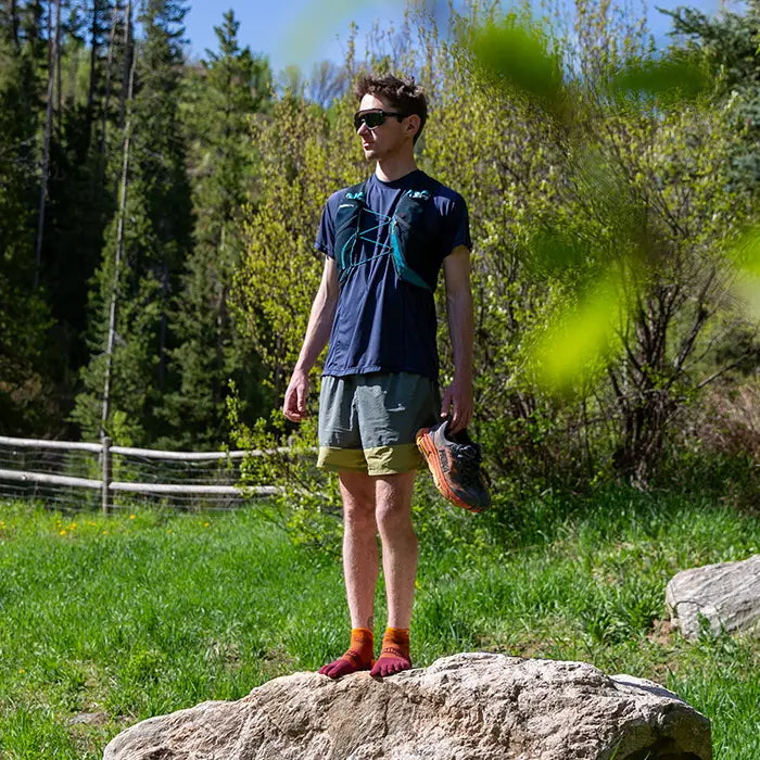 Injinji Trail Midweight Mini Crew Mens Solar full length on a rock