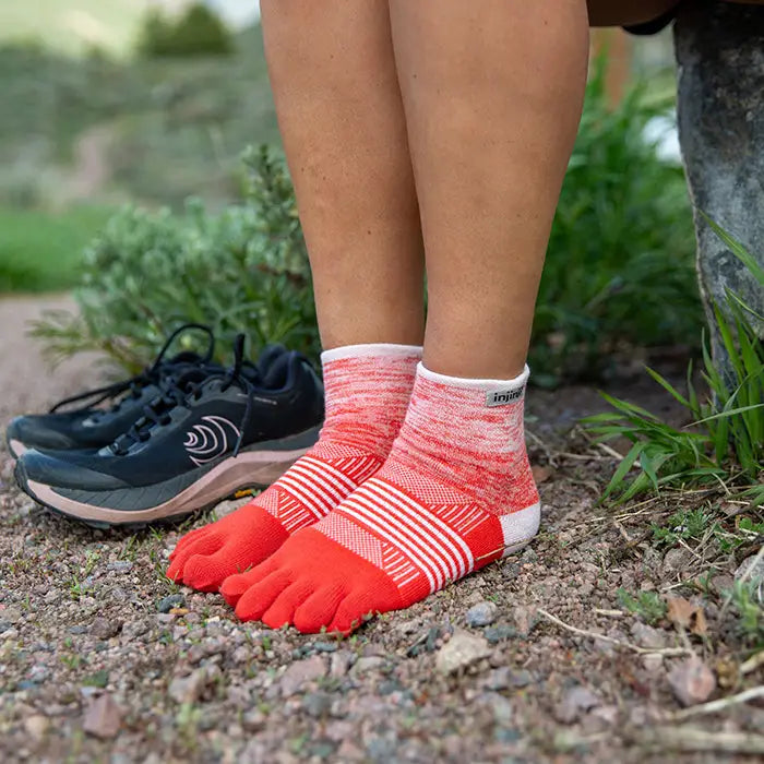 Injinji Trail Midweight Mini Crew Womens Hibiscus Model standing on gravel