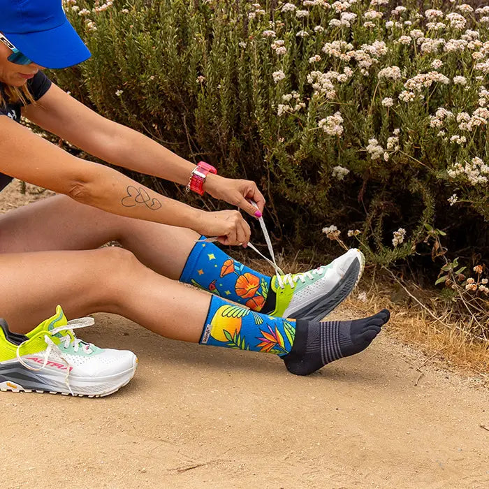 Injinji Artist Designed Hanna Trail Midweight Crew Women's Parrot (AW25) model wearing the socks and lacing shoes