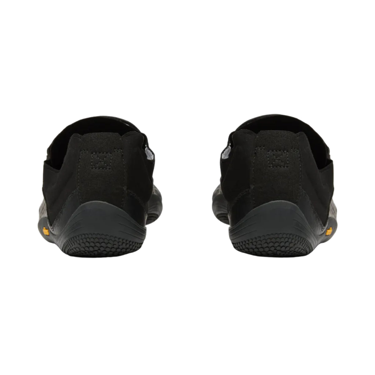 A pair of black slip-on shoes shown from the back, featuring textured black soles and a small yellow accent on the outsole.