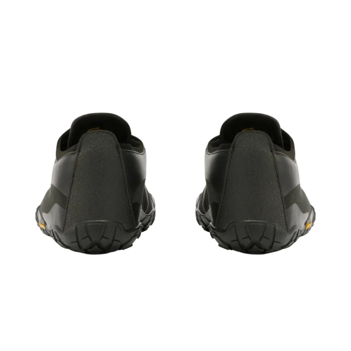 Black slip-on shoes shown from the back, featuring textured rubber soles and a matte finish, photographed against a light gray background.